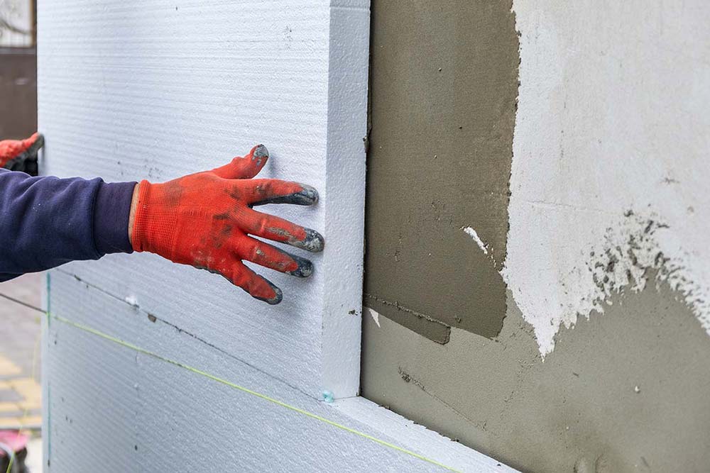 Applicazione di pannello isolante sulla parete esterna